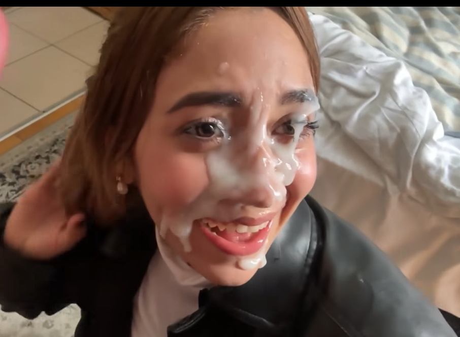 Girl takes a walk in the street while her face is covered in thick cum